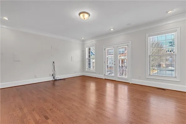 a view of a livingroom with a fireplace a chandelier wooden floor and chandelier