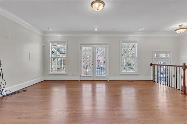 a view of a livingroom with a fireplace a chandelier and wooden floor