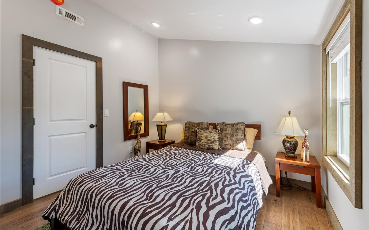 129 Madola Road Epworth, GA 30513 - Photo 36 of 46 a bedroom with a bed and wooden floor