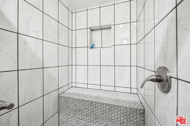 a view of a dining room with furniture a potted plant and wooden floor
