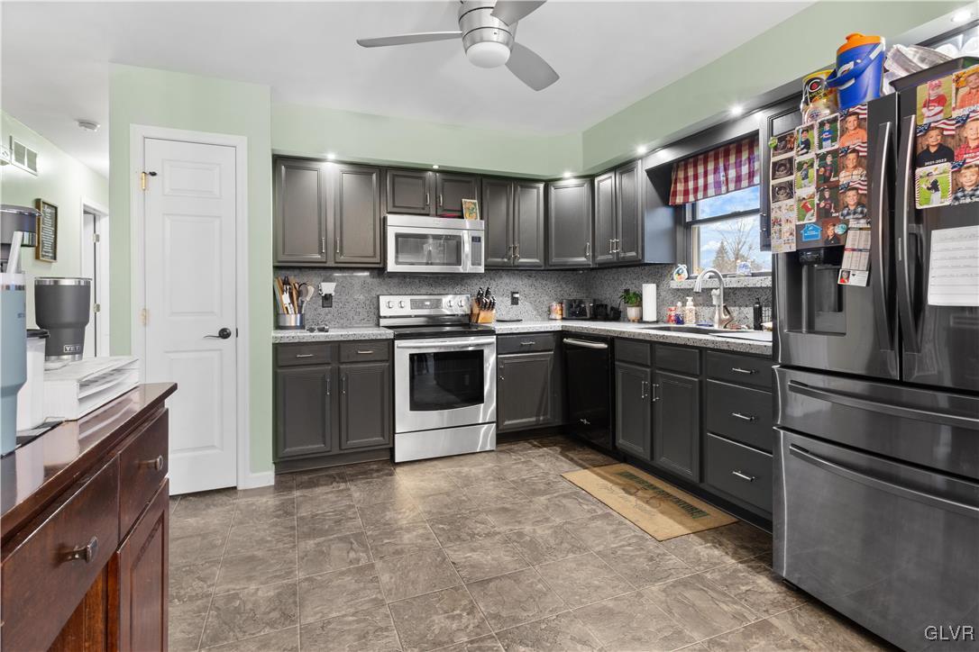 540 Church Road Bath, PA 18014 - Photo 5 of 19 a kitchen with stainless steel appliances granite countertop a stove sink and cabinets