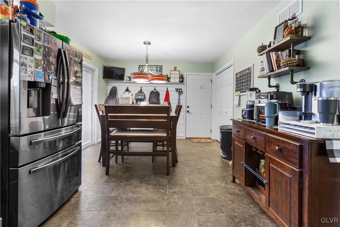540 Church Road Bath, PA 18014 - Photo 6 of 19 a kitchen with stainless steel appliances a stove refrigerator and a dining table with wooden floor