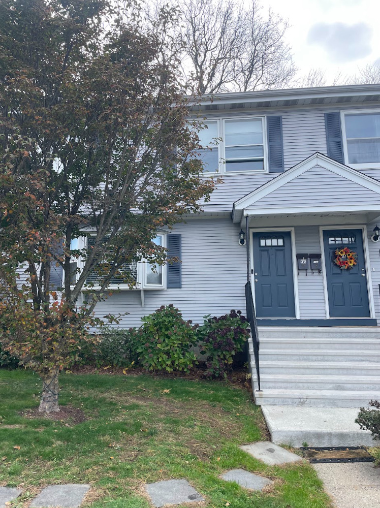 a front view of a house with a garden