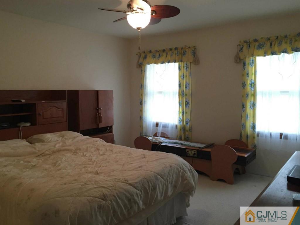 6 Idlewild Road Edison, NJ 08817 - Photo 8 of 15 a bedroom with a bed and a chandelier