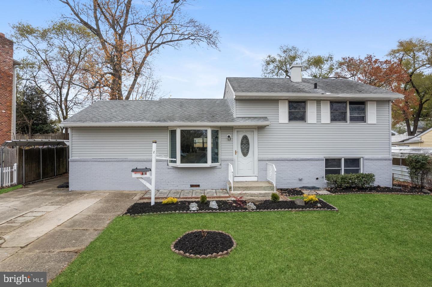 a front view of house with yard and outdoor seating
