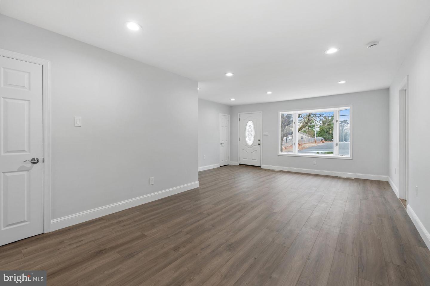 315 Ogden Sta Road Wenonah, NJ 08090 - Photo 2 of 10 an empty room with wooden floor and windows