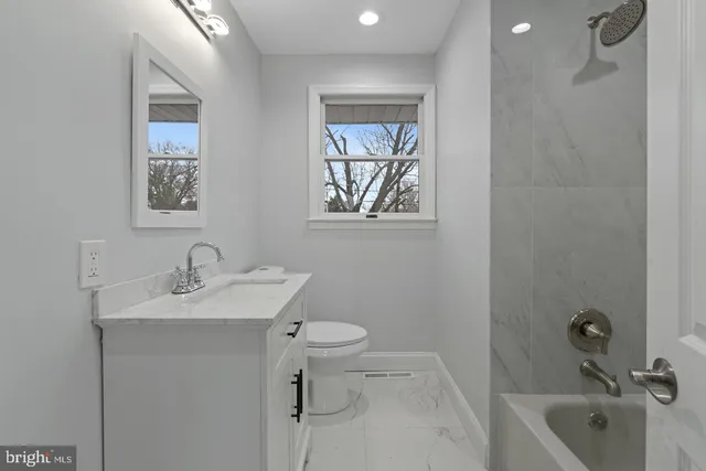 a bathroom with a sink toilet and bathtub