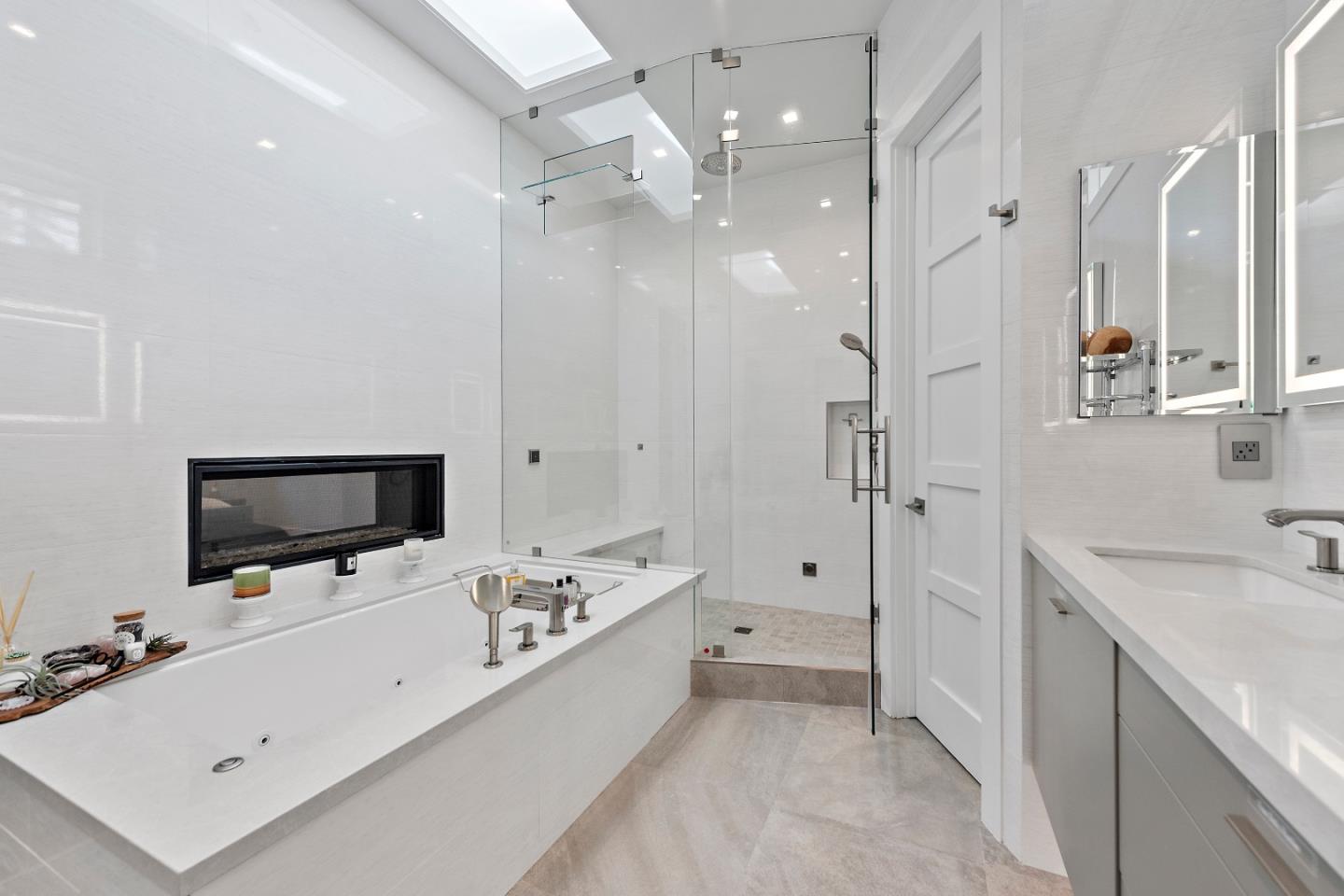 88 Park Drive Atherton, CA 94027 - Photo 19 of 40 a large white room with a large mirror and a flat screen tv