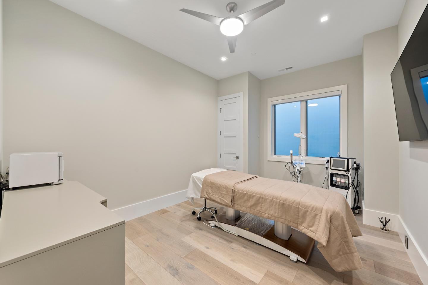 88 Park Drive Atherton, CA 94027 - Photo 27 of 40 a bedroom with a bed and a chandelier