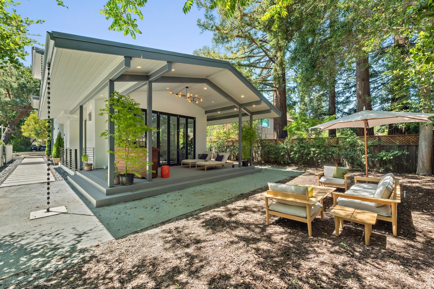 88 Park Drive Atherton, CA 94027 - Photo 32 of 40 a view of a patio with table and chairs potted plants and large tree