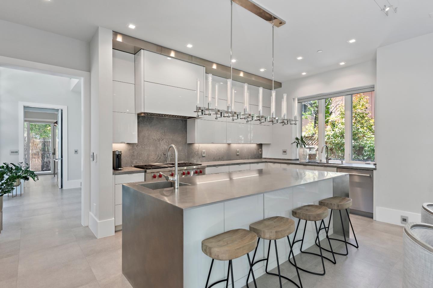 88 Park Drive Atherton, CA 94027 - Photo 5 of 40 a kitchen with stainless steel appliances granite countertop a stove top oven a sink with a dining table and chairs