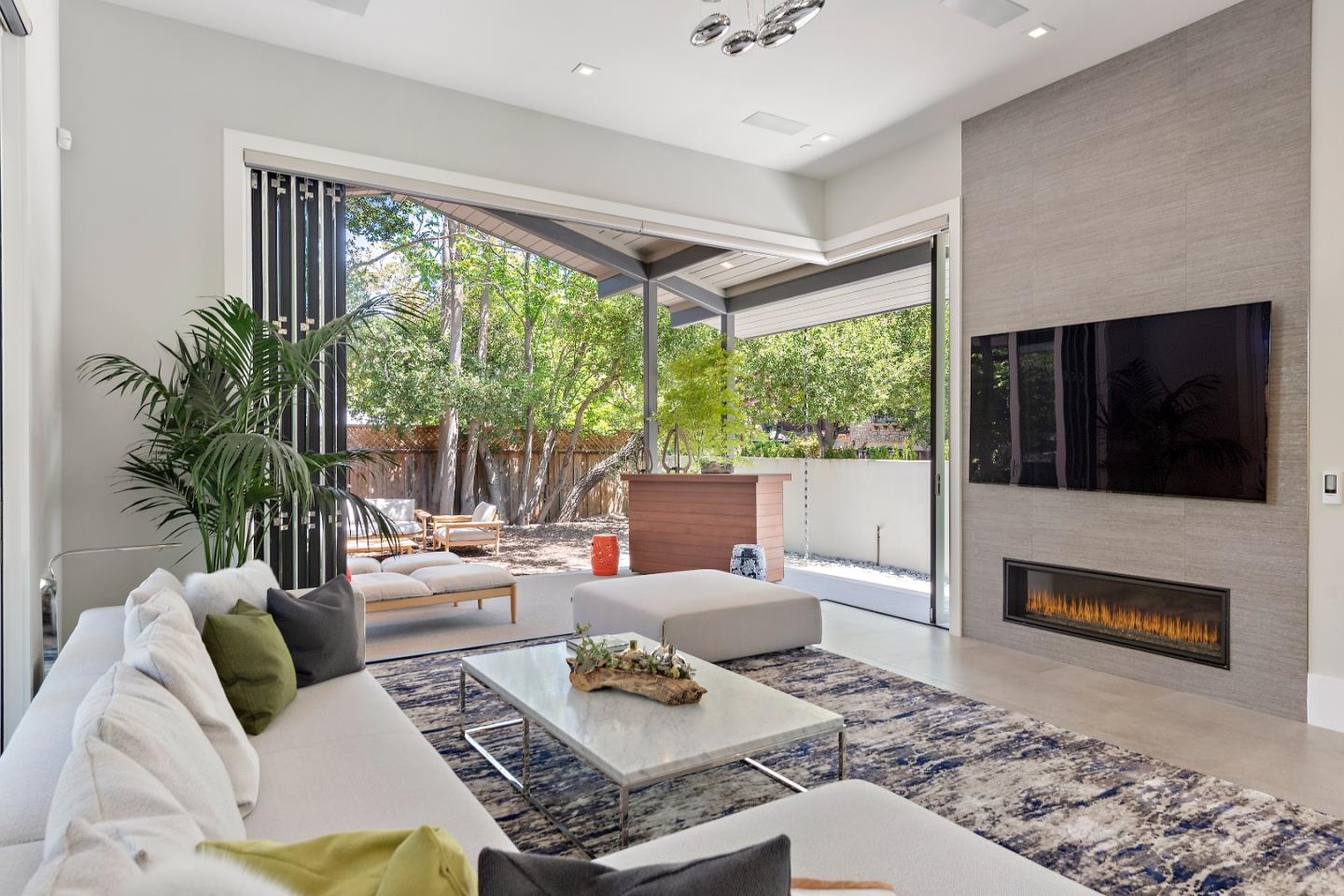 88 Park Drive Atherton, CA 94027 - Photo 9 of 40 a living room with furniture tv and a fireplace
