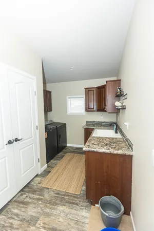 a spacious bathroom with a granite countertop sink and a mirror