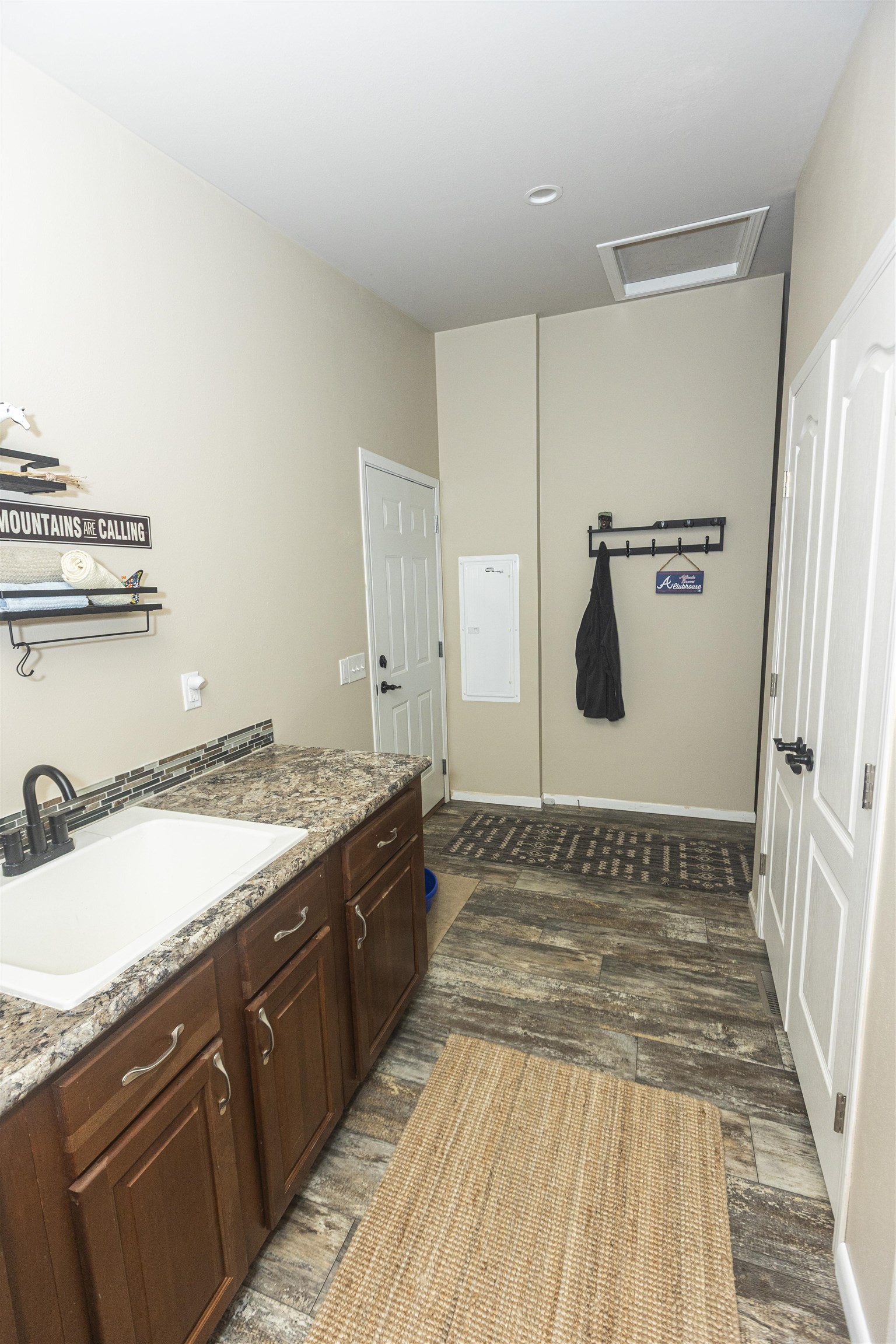 2432 Pioneer Way Rifle, CO 81650 - Photo 12 of 28 a spacious bathroom with a granite countertop sink and a mirror