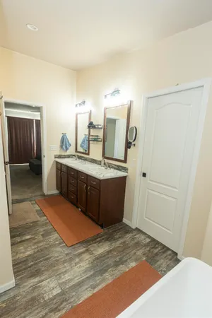 a bathroom with a granite countertop sink a toilet and a shower
