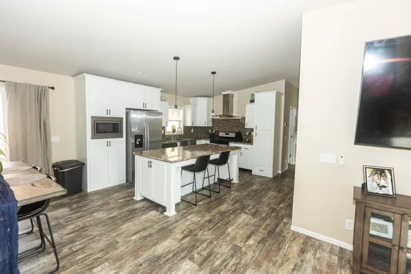 a kitchen with kitchen island a sink stove and refrigerator