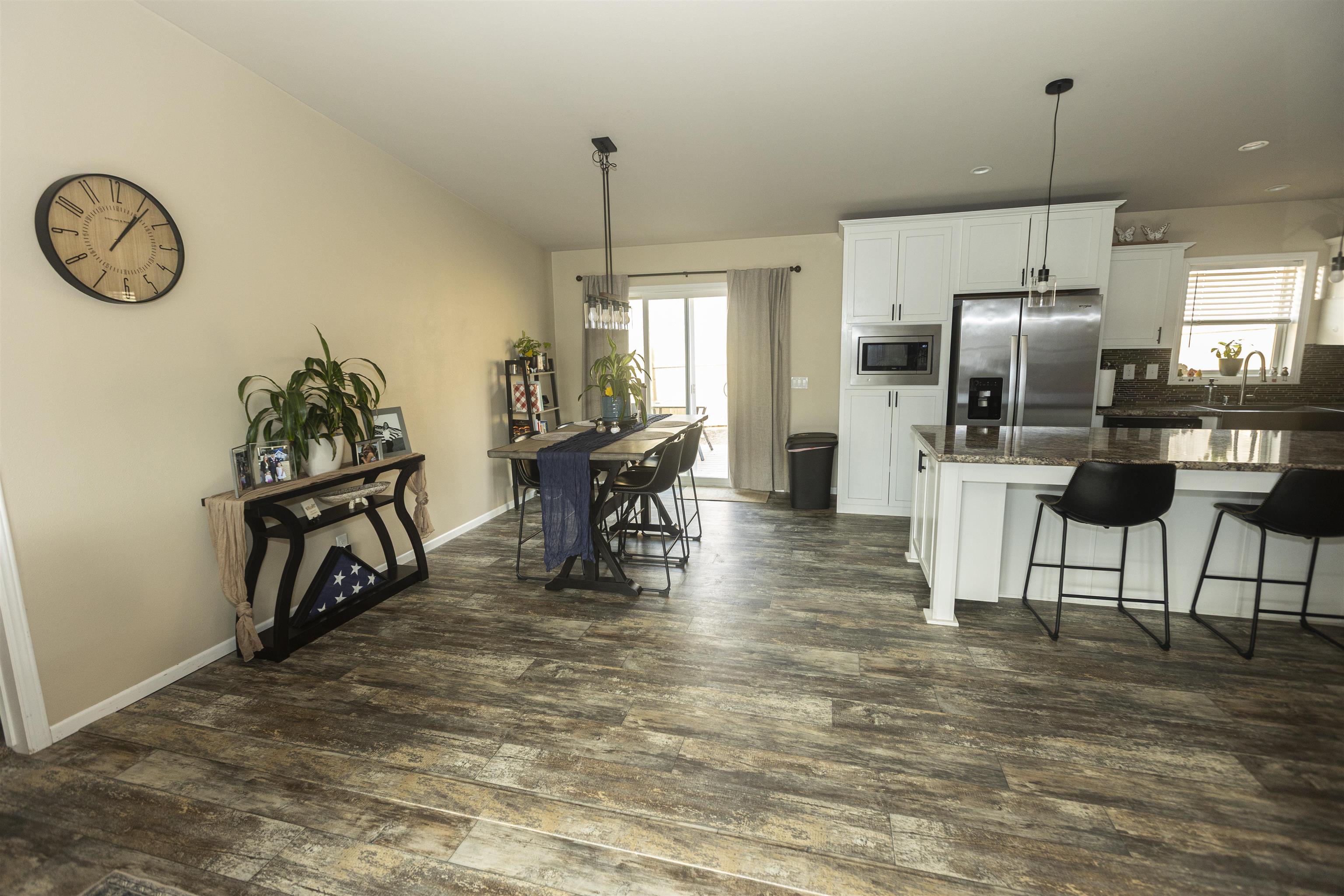 2432 Pioneer Way Rifle, CO 81650 - Photo 8 of 28 a view of a kitchen with kitchen island dining table and stainless steel appliances