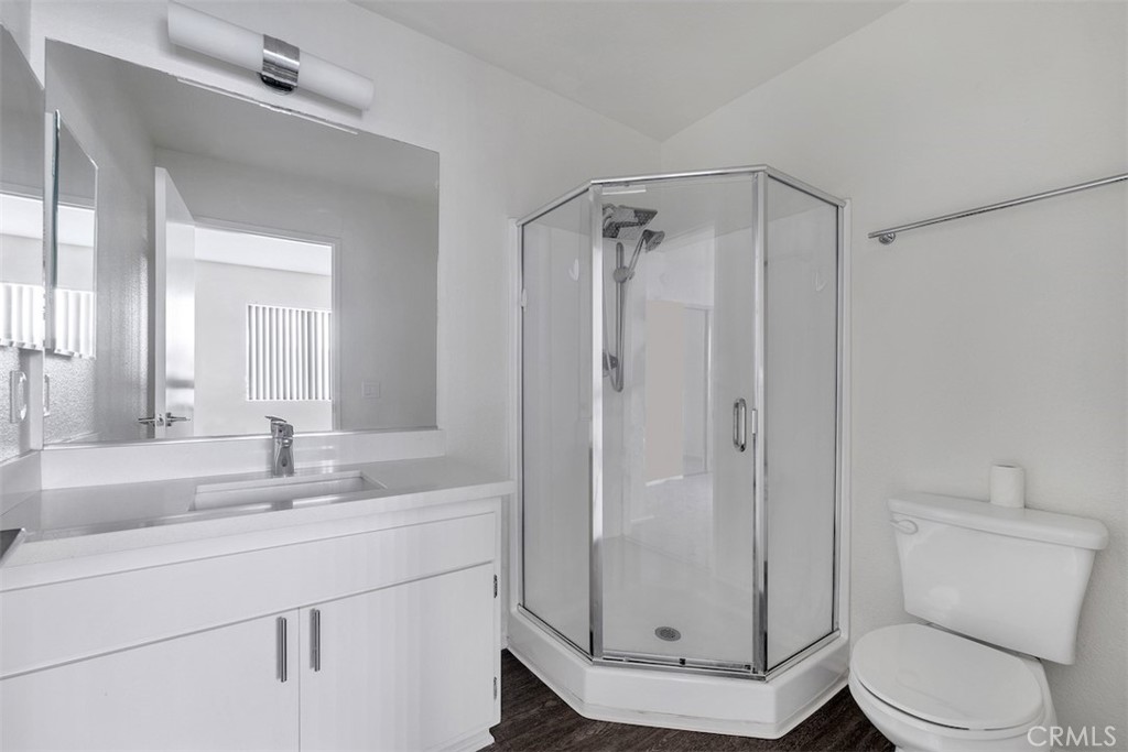 14218 Victory Boulevard Van Nuys, CA 91401 - Photo 14 of 16 a bathroom with a sink a toilet and a mirror