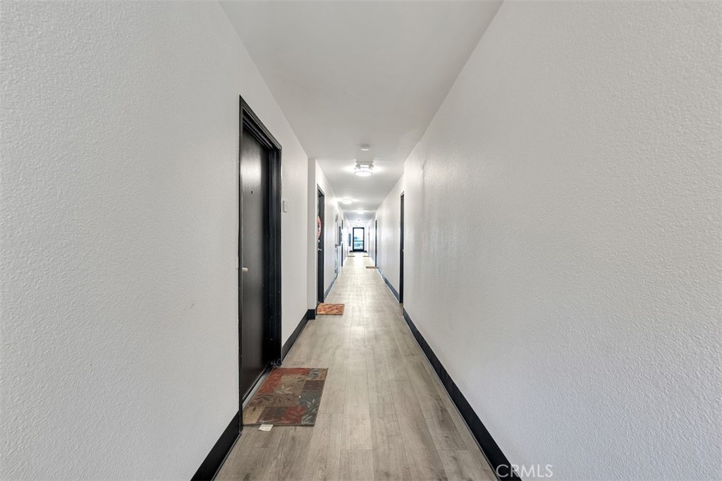 14218 Victory Boulevard Van Nuys, CA 91401 - Photo 5 of 16 a view of a hallway with wooden floor