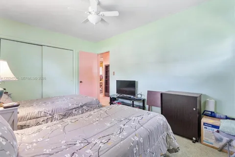 a bedroom with a bed desk and chair