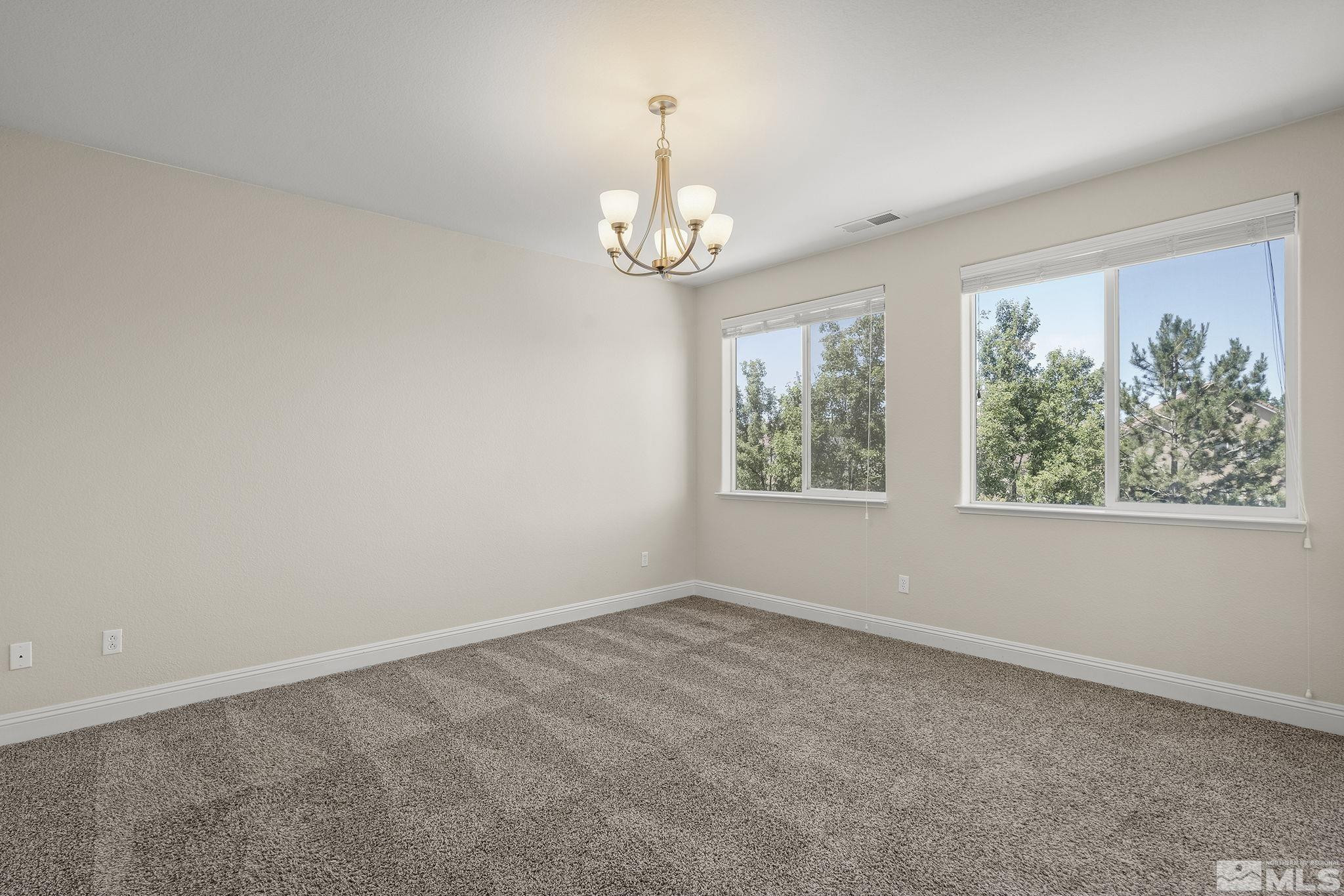 1755 Cavern Drive Reno, NV 89521 - Photo 15 of 25 an empty room with windows and outdoor view