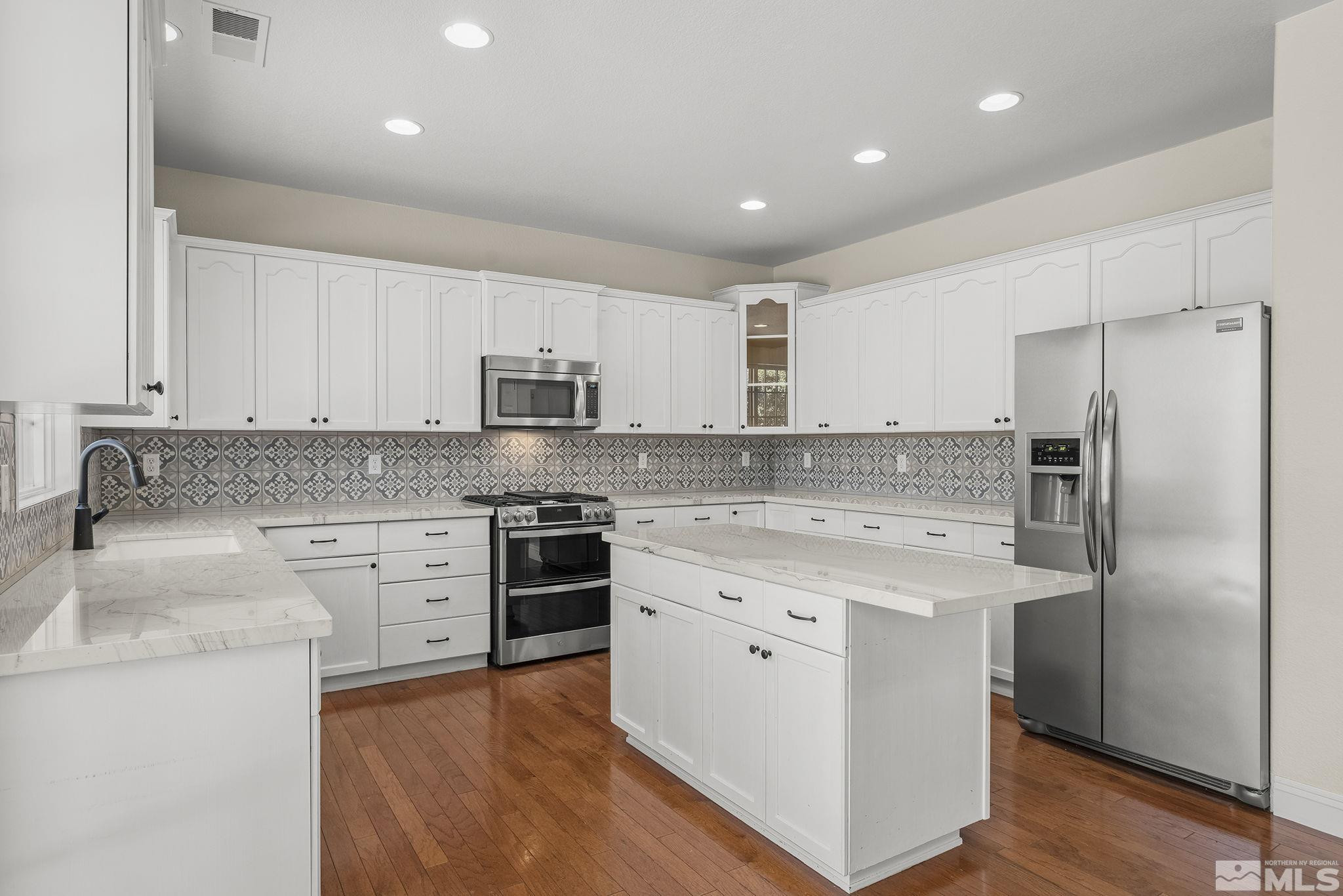 1755 Cavern Drive Reno, NV 89521 - Photo 18 of 25 a kitchen with stainless steel appliances granite countertop a stove a sink and a refrigerator