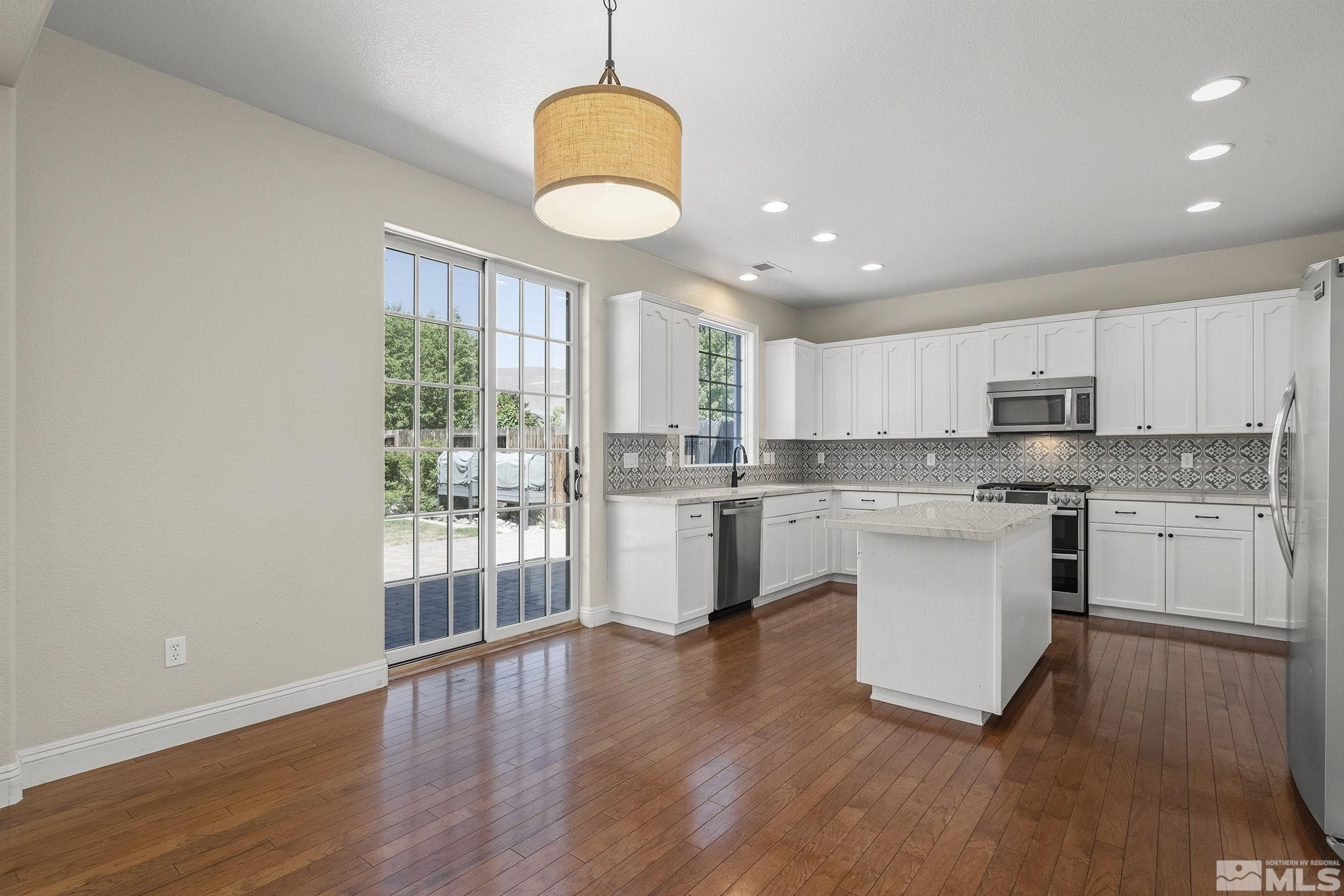 1755 Cavern Drive Reno, NV 89521 - Photo 19 of 25 a kitchen with white cabinets and window