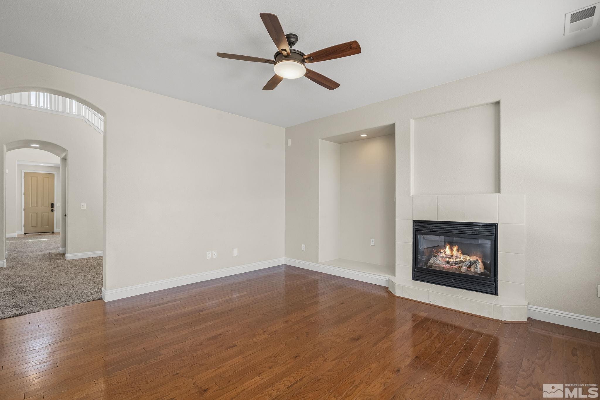 1755 Cavern Drive Reno, NV 89521 - Photo 20 of 25 a view of an empty room with wooden floor and a ceiling fan