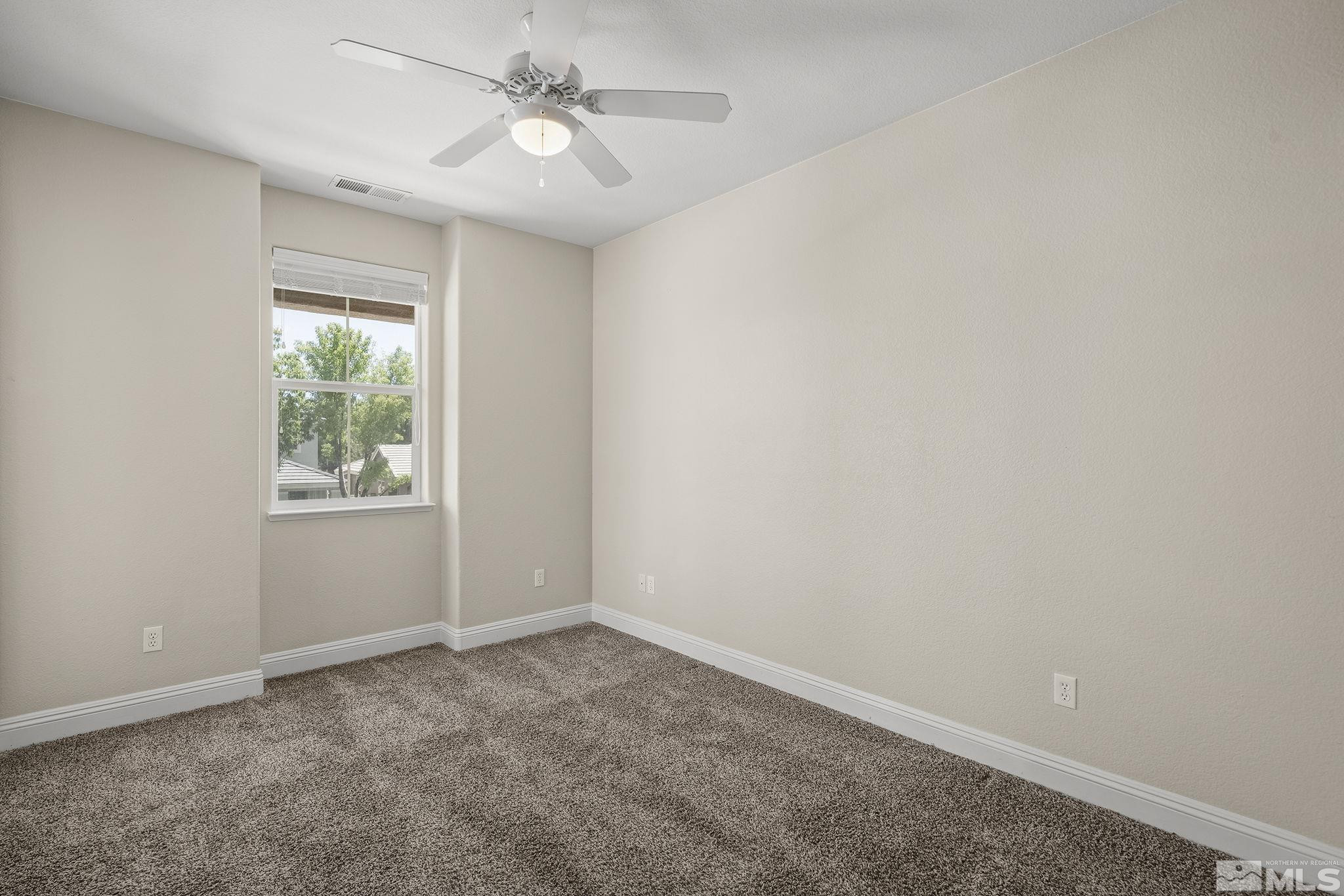 1755 Cavern Drive Reno, NV 89521 - Photo 7 of 25 an empty room with windows and fan