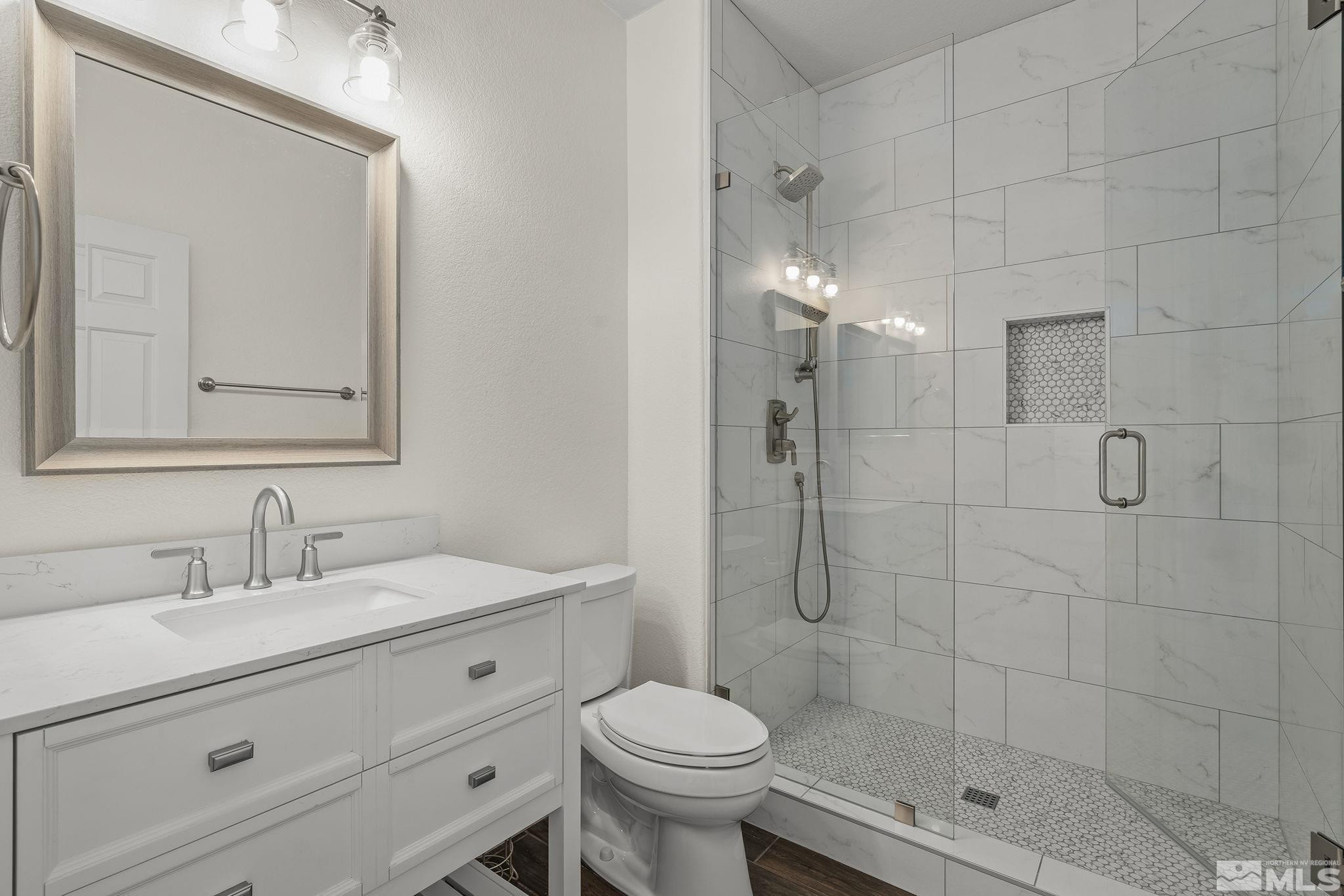 1755 Cavern Drive Reno, NV 89521 - Photo 10 of 25 a bathroom with a sink toilet and shower