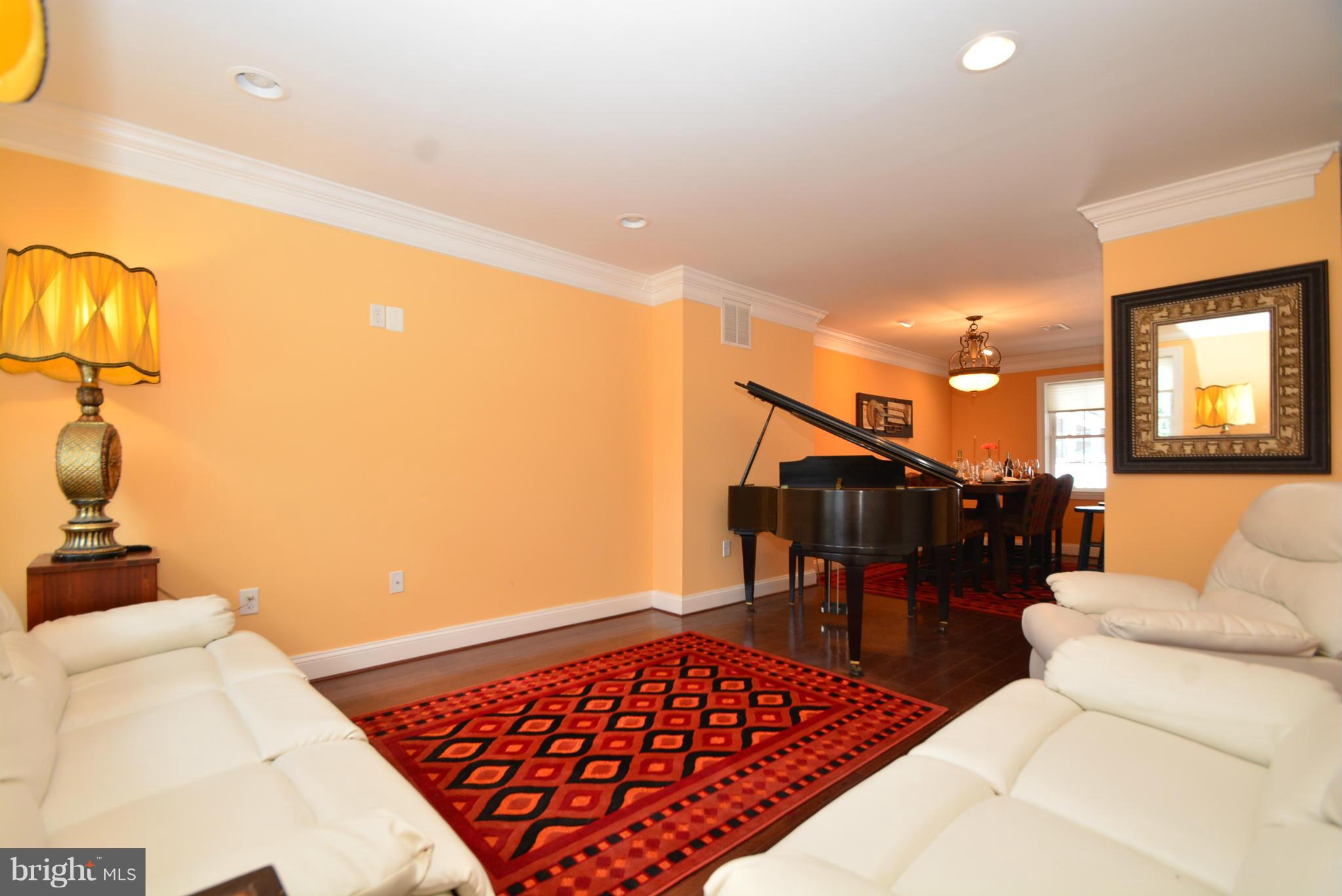 1509 Lochwood Road Baltimore, MD 21218 - Photo 2 of 30 a living room with furniture a rug and a chandelier