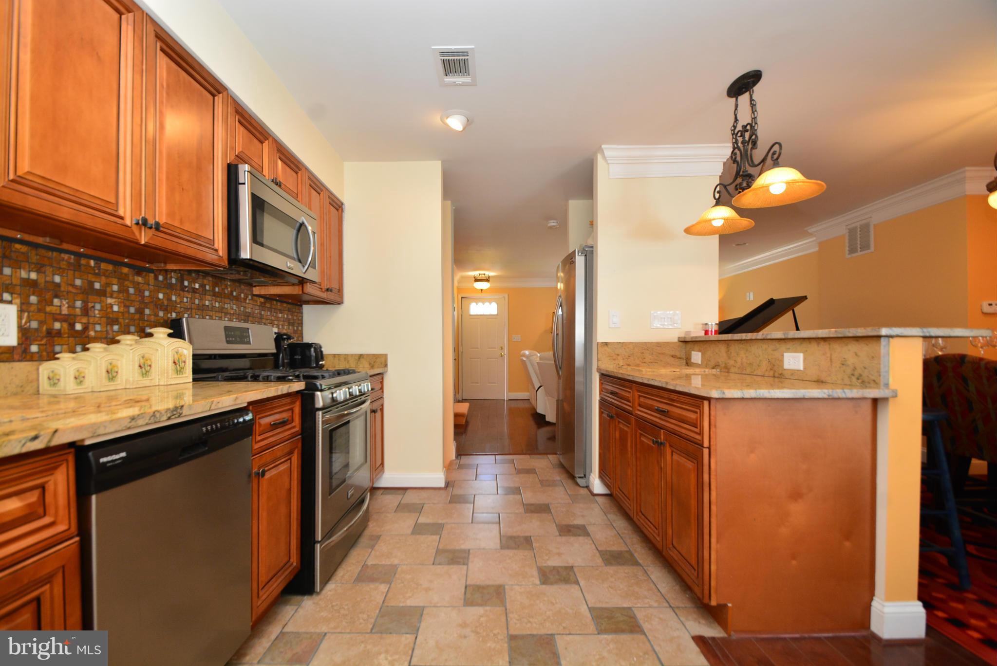 1509 Lochwood Road Baltimore, MD 21218 - Photo 11 of 30 a kitchen with stainless steel appliances granite countertop a sink a stove and a refrigerator