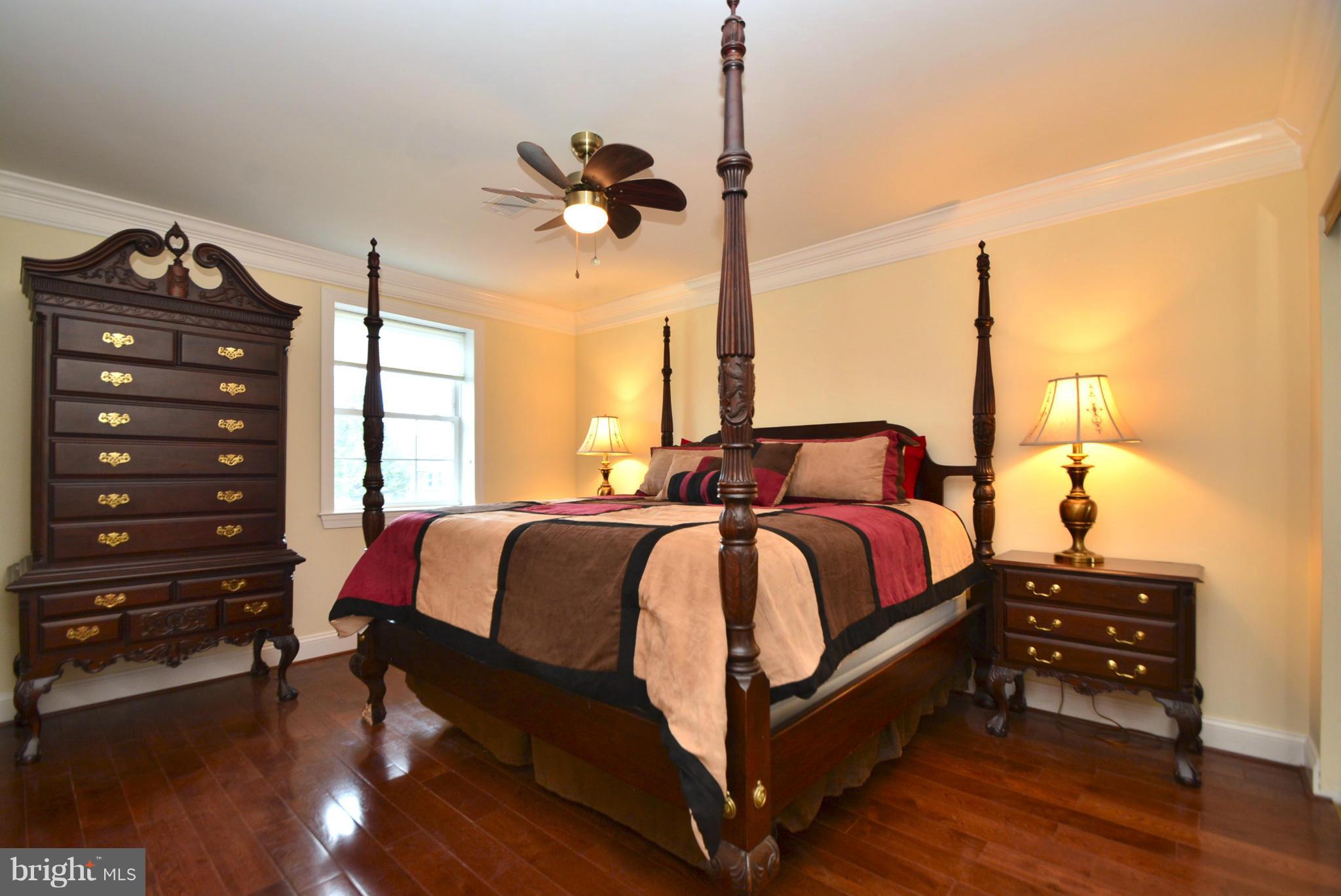 1509 Lochwood Road Baltimore, MD 21218 - Photo 14 of 30 a bedroom with a bed a dresser and a window
