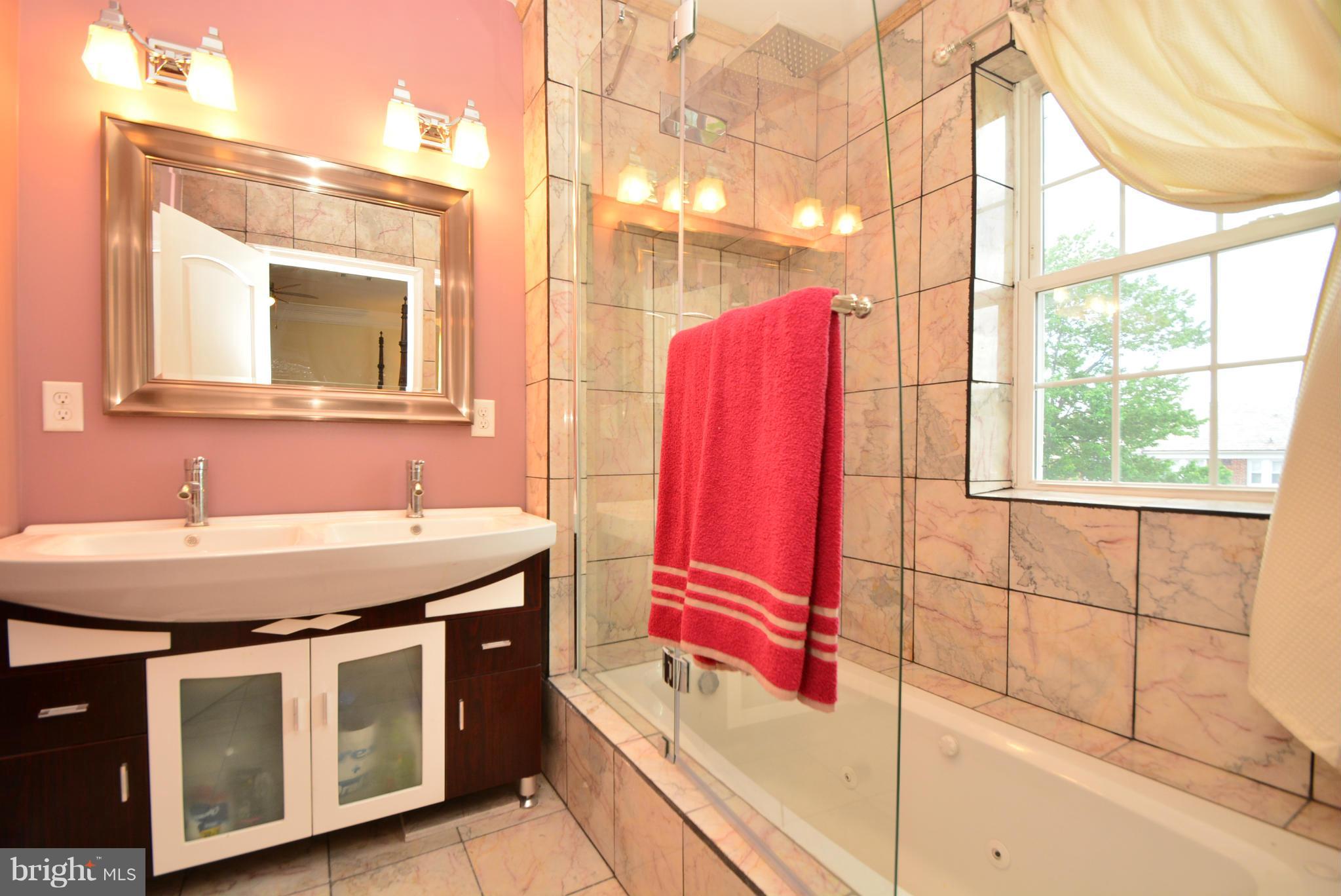 1509 Lochwood Road Baltimore, MD 21218 - Photo 15 of 30 a bathroom with a granite countertop sink and a mirror