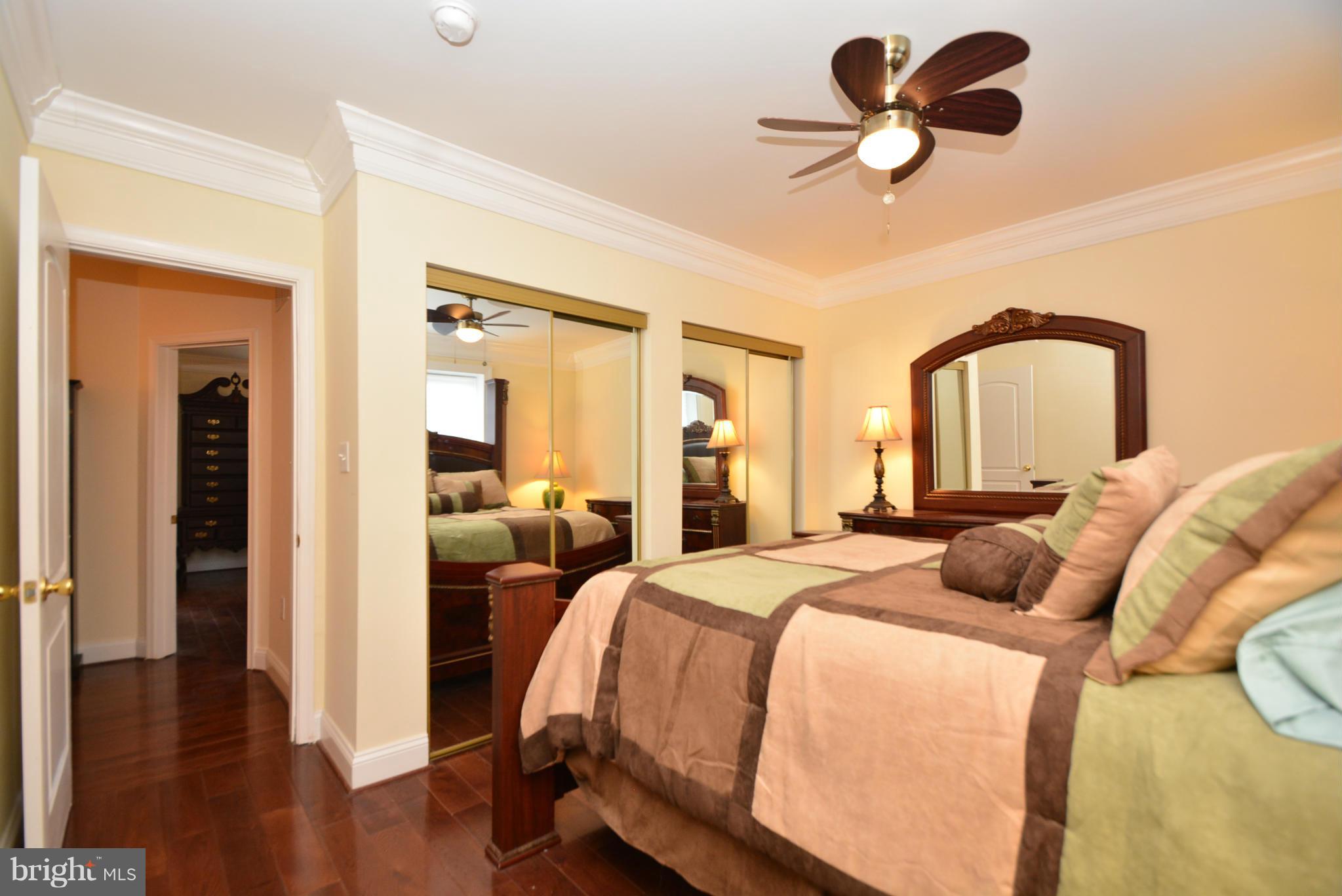 1509 Lochwood Road Baltimore, MD 21218 - Photo 18 of 30 a bedroom with bed and a chandelier