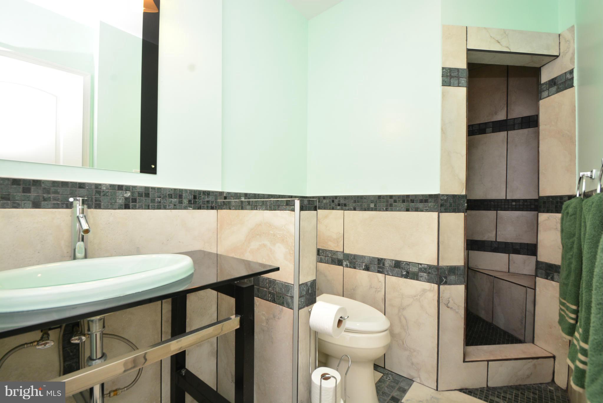1509 Lochwood Road Baltimore, MD 21218 - Photo 19 of 30 a bathroom with a sink a toilet and a mirror