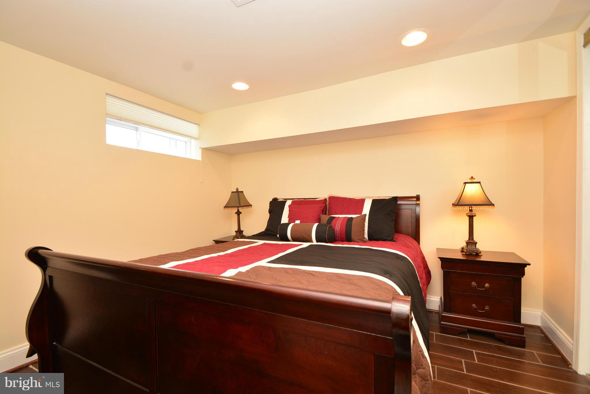 1509 Lochwood Road Baltimore, MD 21218 - Photo 21 of 30 a bedroom with a bed and a night stand