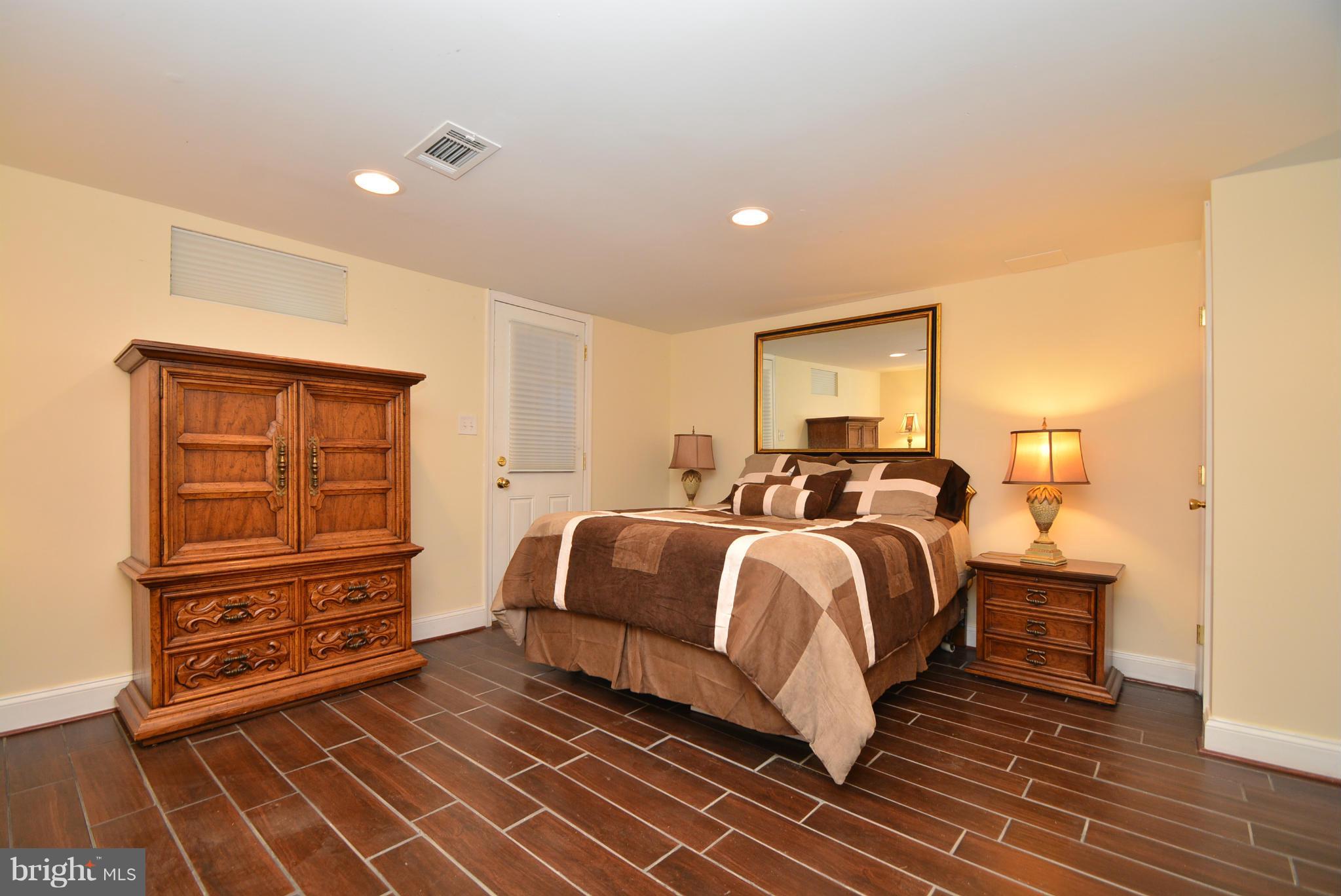 1509 Lochwood Road Baltimore, MD 21218 - Photo 23 of 30 a spacious bedroom with a bed and a dresser
