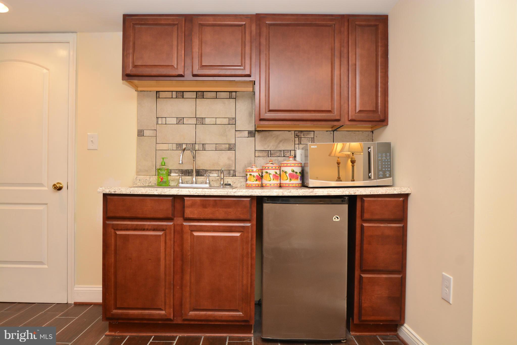 1509 Lochwood Road Baltimore, MD 21218 - Photo 25 of 30 a kitchen with granite countertop cabinets and window