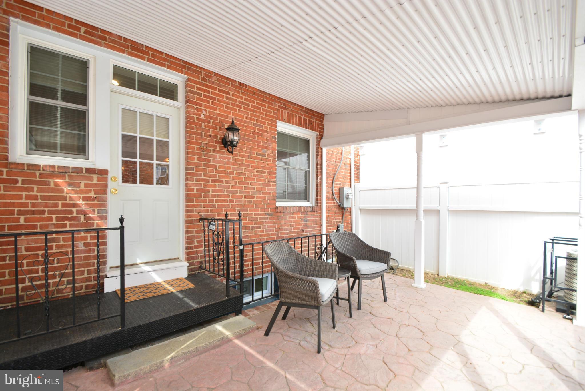 1509 Lochwood Road Baltimore, MD 21218 - Photo 28 of 30 a balcony with table and chairs and potted plants