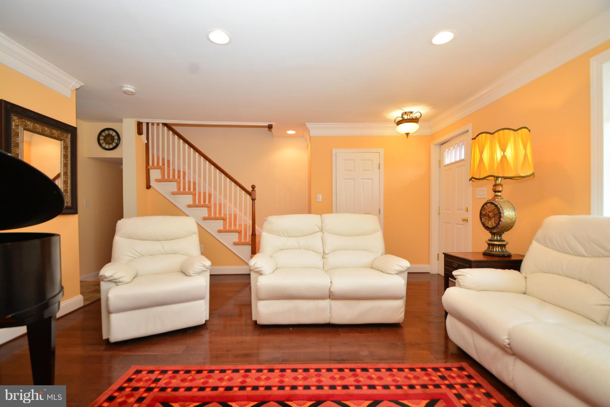 1509 Lochwood Road Baltimore, MD 21218 - Photo 4 of 30 a living room with furniture and a painting on the wall