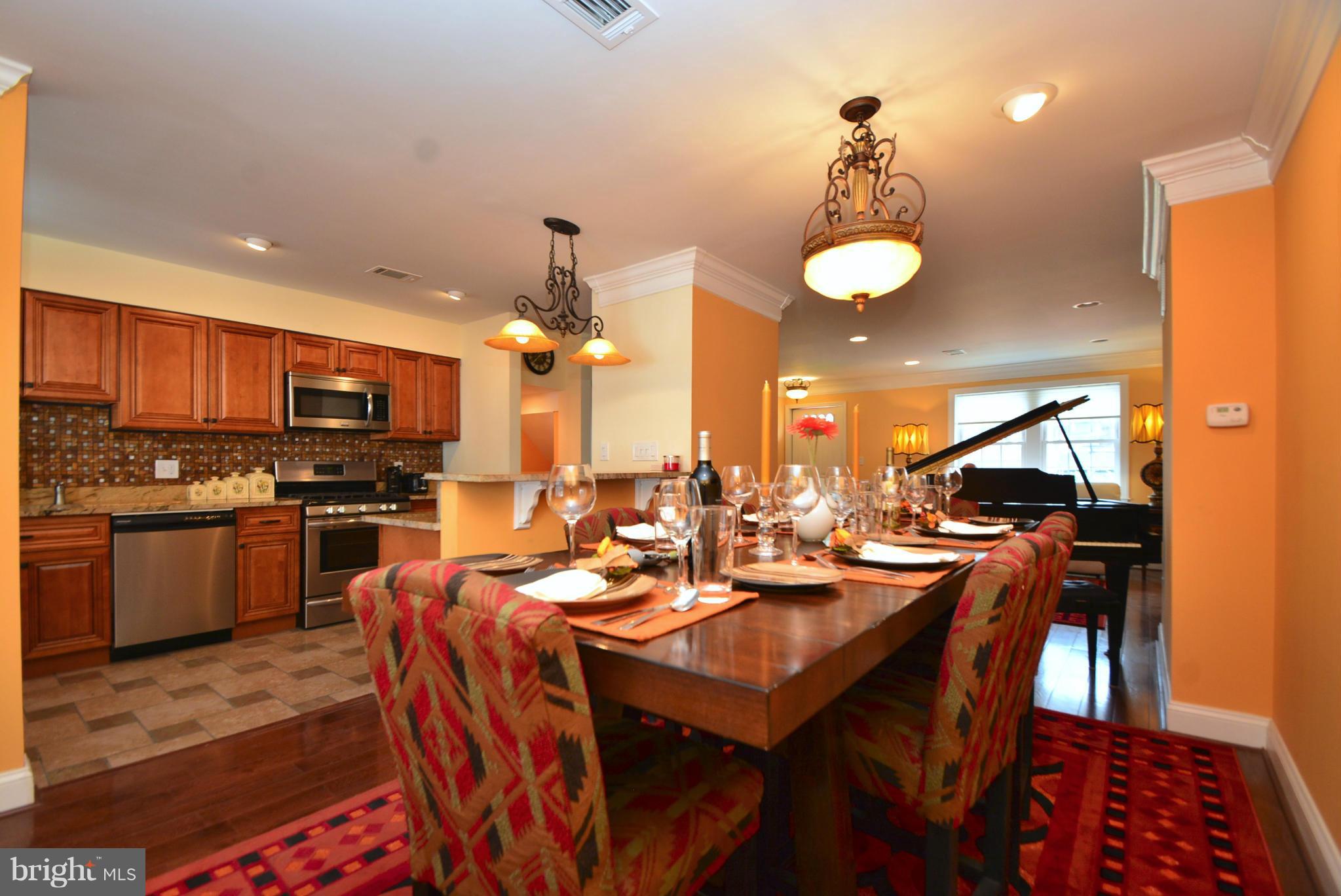 1509 Lochwood Road Baltimore, MD 21218 - Photo 7 of 30 a kitchen with a table chairs stove and microwave