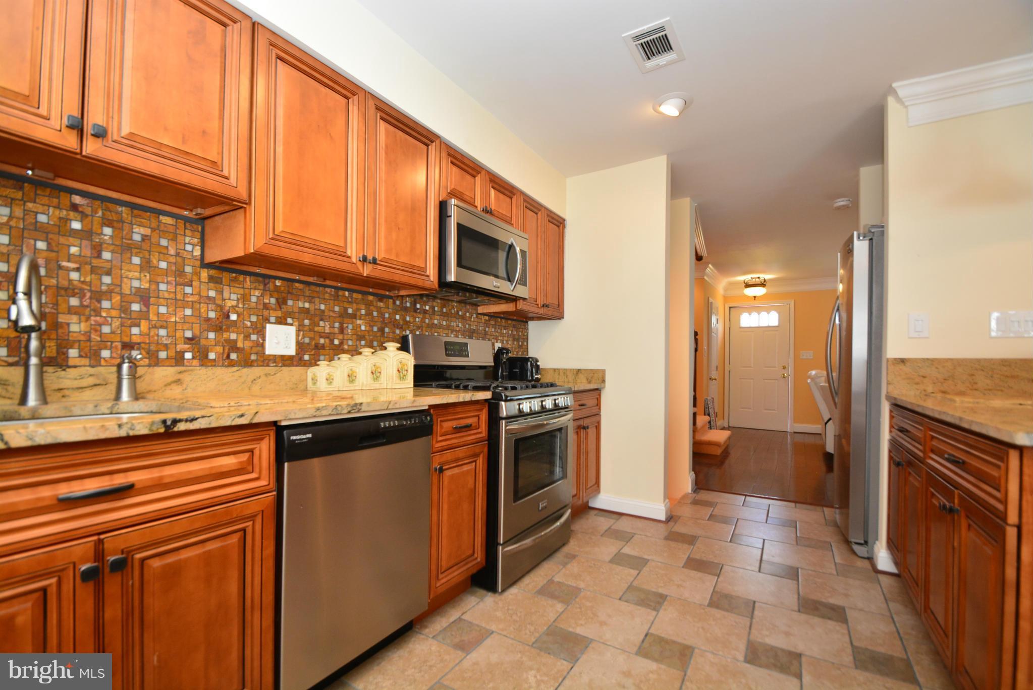 1509 Lochwood Road Baltimore, MD 21218 - Photo 10 of 30 a kitchen with stainless steel appliances granite countertop a stove a sink and a refrigerator