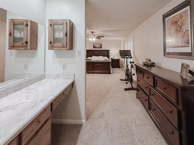 a kitchen with granite countertop a sink and cabinets