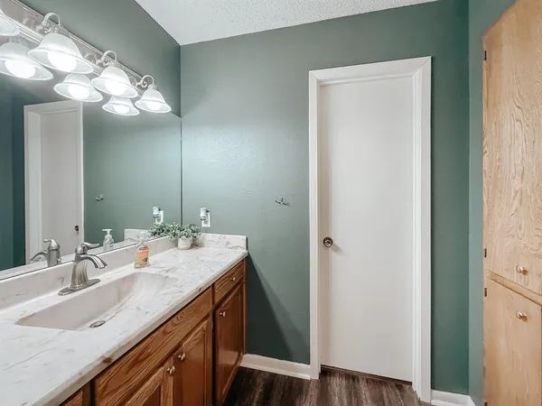 a bathroom with a sink a light fixture and a mirror