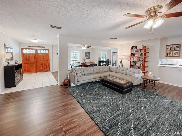 a living room with furniture and wooden floor