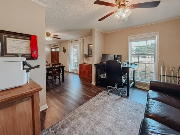 a living room with furniture and a flat screen tv with wooden floor