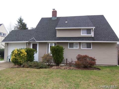 46 Friendly Road Hicksville, NY 11801 - Photo 1 of 1 a front view of a house with a garden and plants