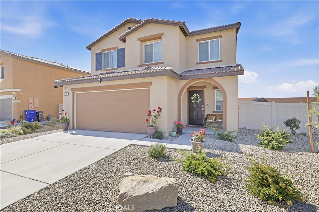 10143 Colten Ridge Adelanto, CA 92301 - Photo 3 of 36 a front view of a house with garden
