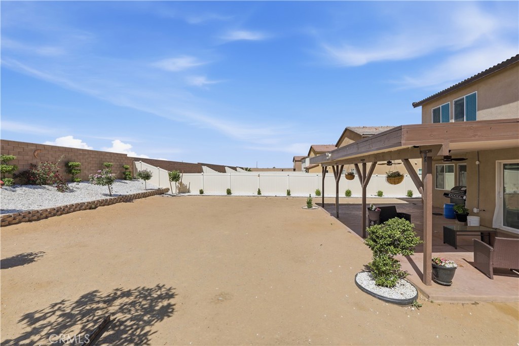 10143 Colten Ridge Adelanto, CA 92301 - Photo 34 of 36 a view of a house with a yard and potted plants